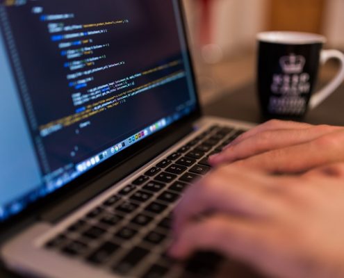 employee using laptop and coding injection